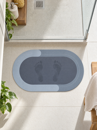 Footprints drying on the absorbent bath mat