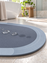 Close-up of water droplets on the bath mat surface